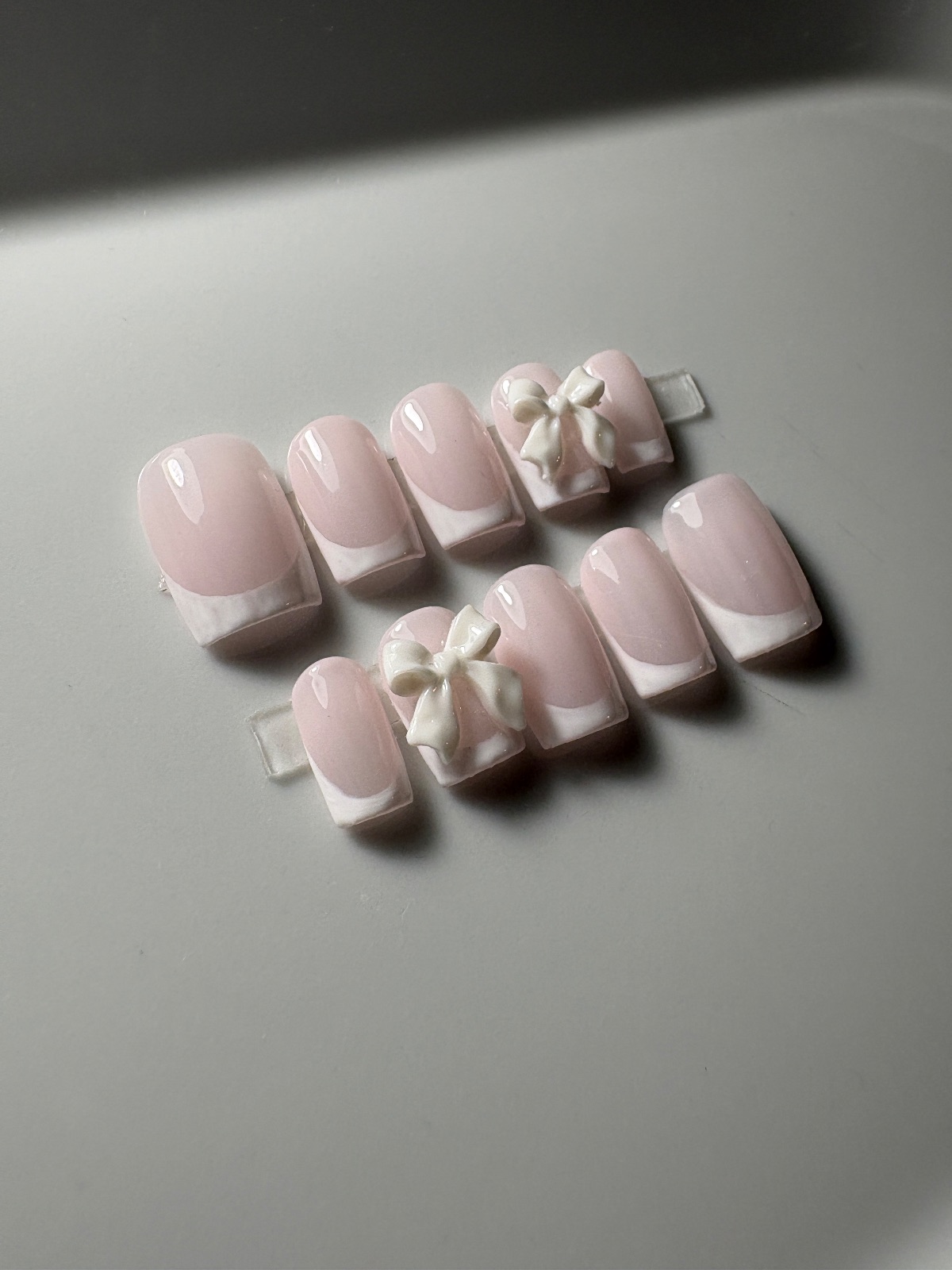 Hand-painted press-on nails in a square shape, Classic white French with a bow design, photo 3