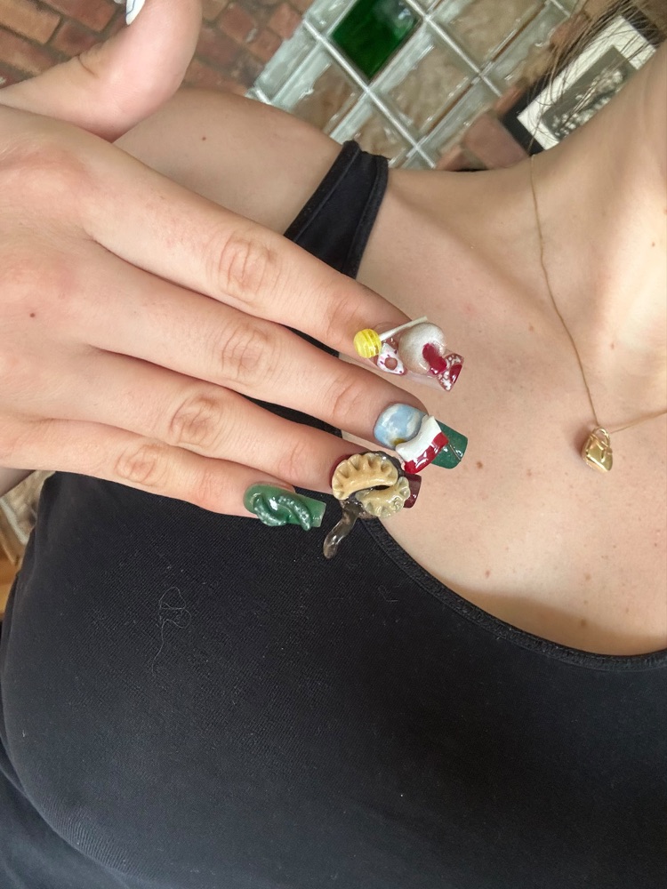 Long coffin nails with hand-sculpted 3D charms: a lollipop, a bow and a dumpling