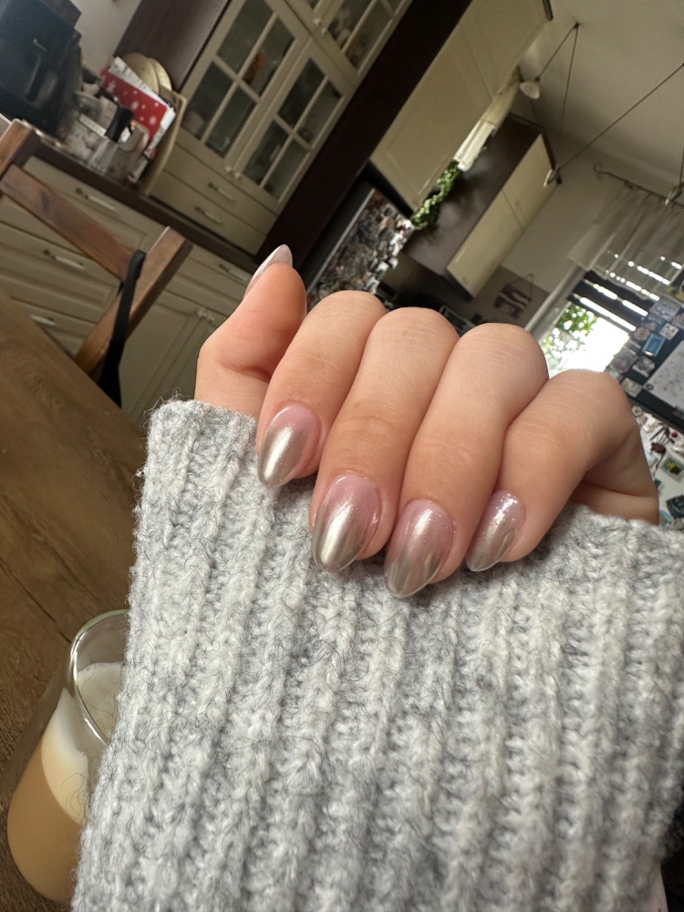 Pearly chrome almond nails in kitchen light