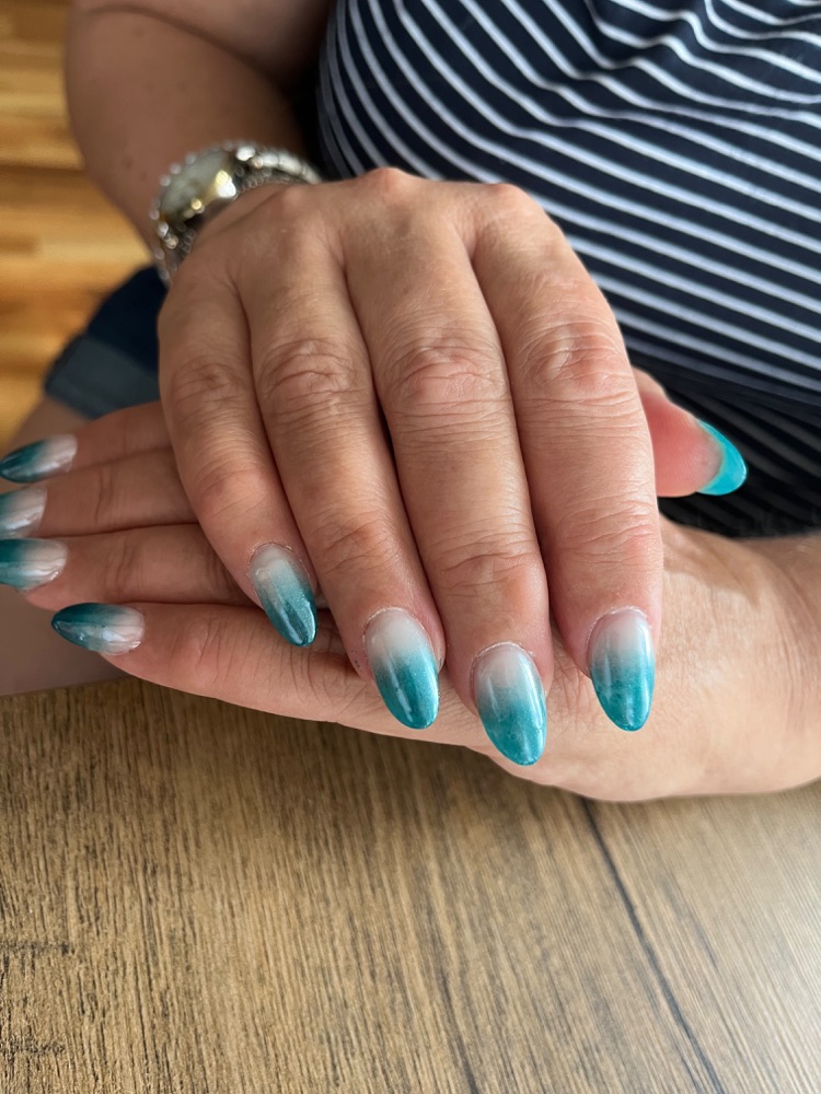 Teal glitter ombré nails fading from milky white to sea green